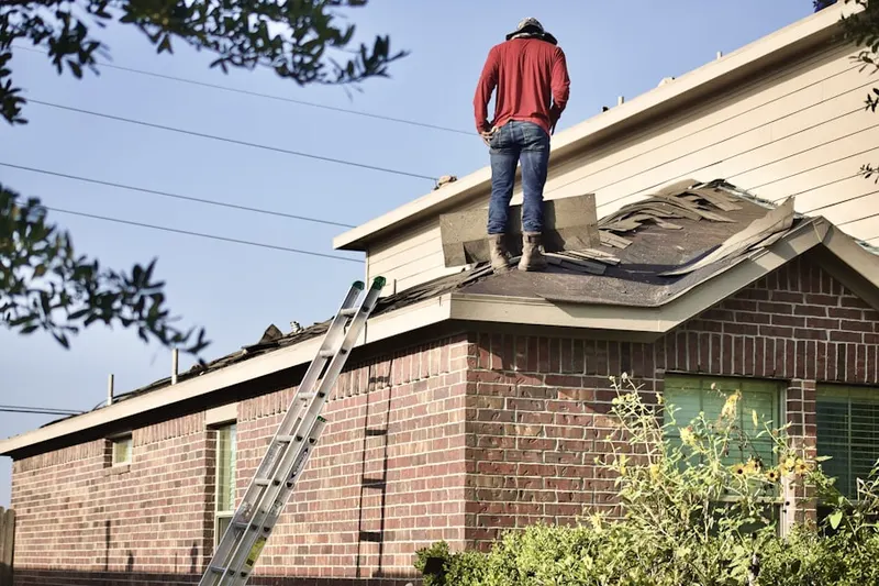 Professional roofer working on a residential roof in Buzzards Bay
